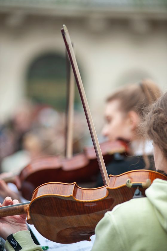 Violinists performing at an outdoor event